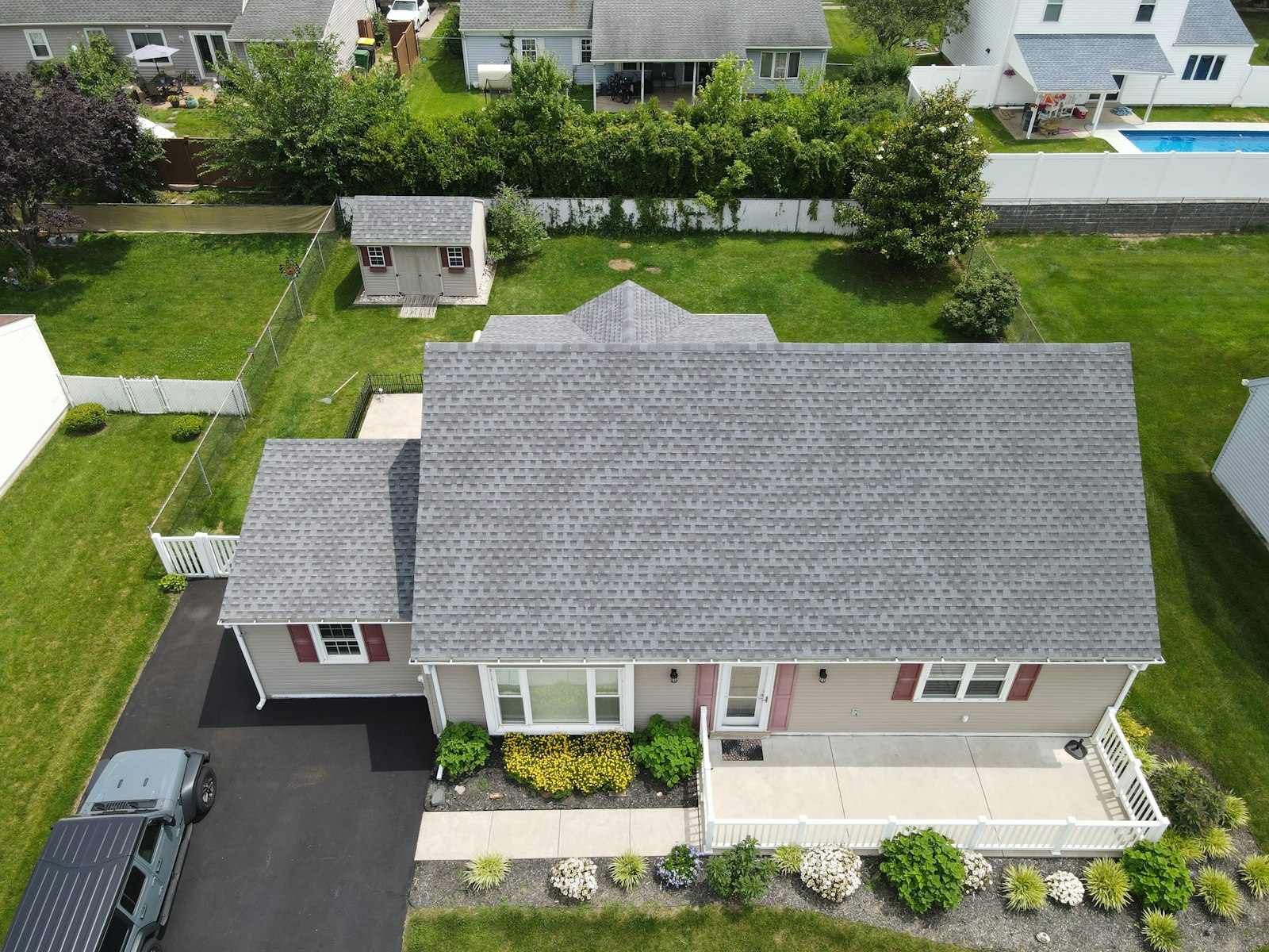 Aerial view of a suburban home with a new gray shingle roof