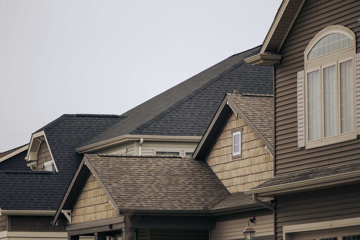 Row of homes with new dark shingle roofs