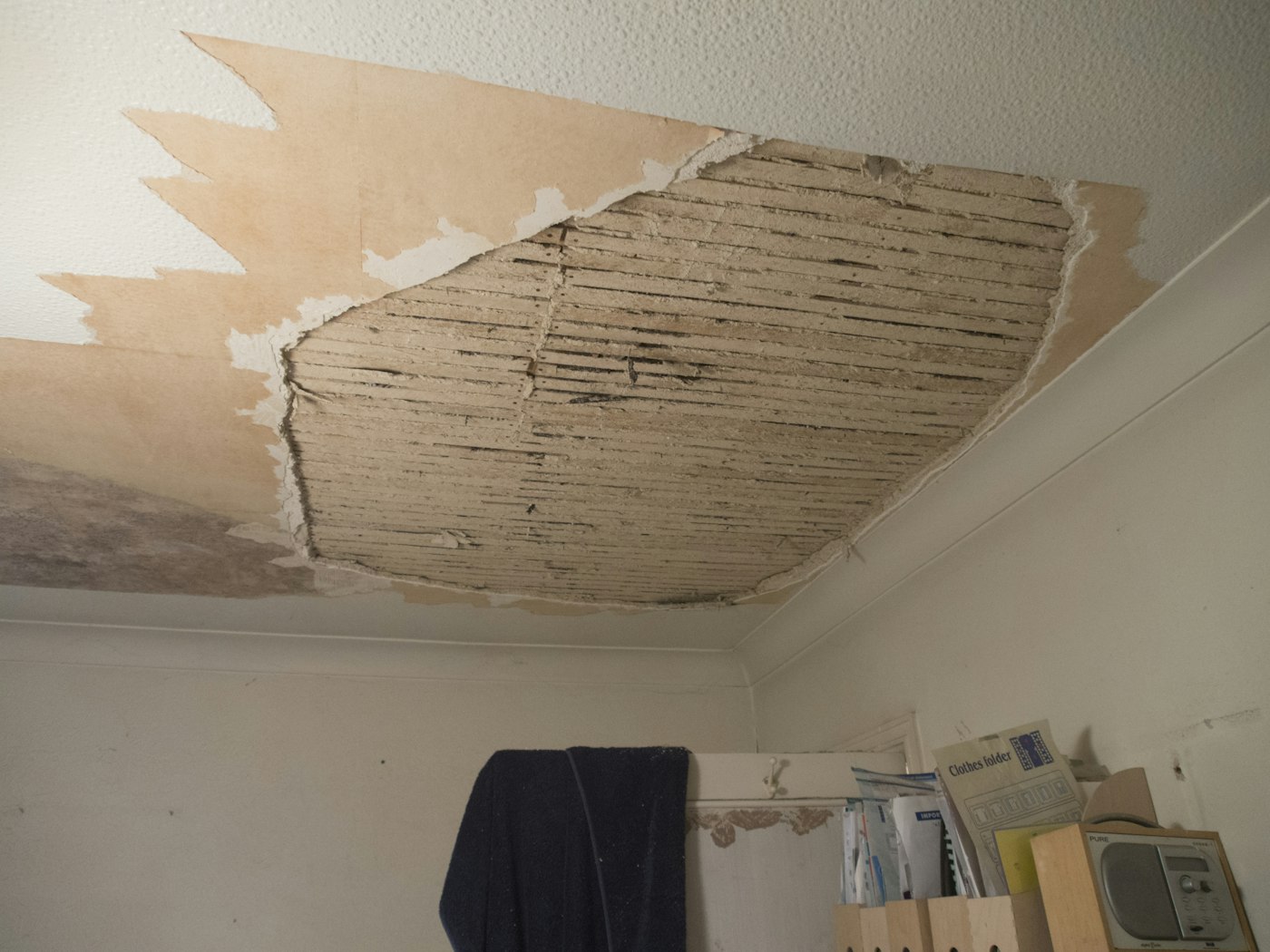 Ceiling with water damage and peeling drywall